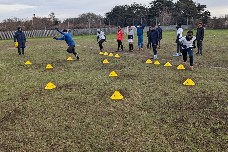 Players working through a cone dribbling drill
