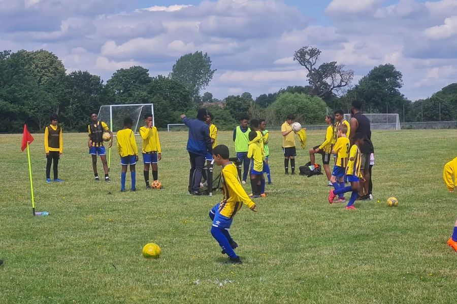 Young players in Shooting Stars yellow at a training session