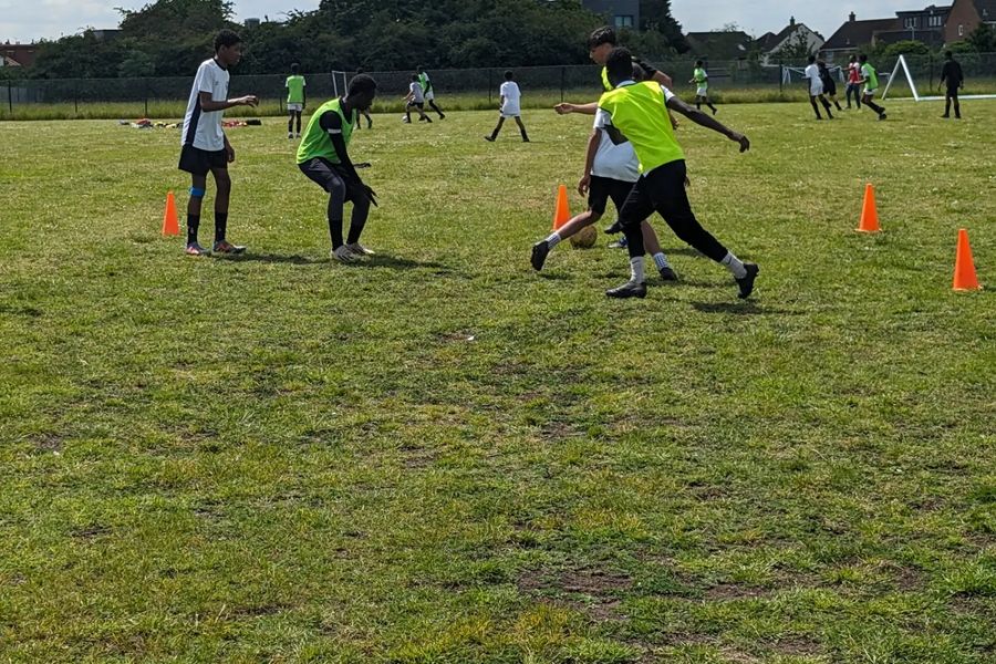 Players in bibs playing a small-sided game at training